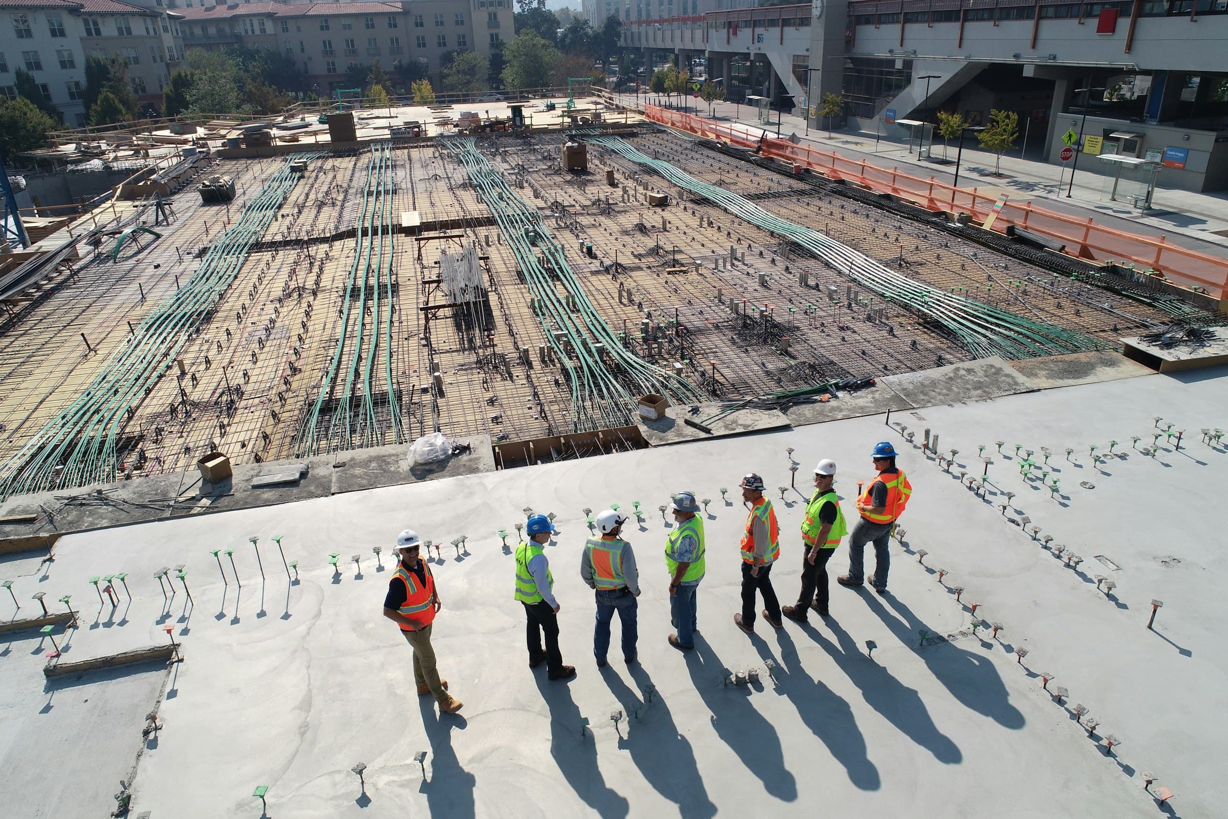 Crew placing rebar across a large slab before the pour